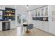 Eat-in kitchen with white cabinetry, subway tile backsplash, and a breakfast nook by the door at 3104 Harrison Ave # A6, Orlando, FL 32804
