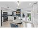 Modern kitchen offers white cabinets, stainless steel appliances, stylish decor, and access to the outdoor patio at 3104 Harrison Ave # A6, Orlando, FL 32804