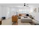This chic living room features recessed lighting, plantation shutters, tile floors, and comfortable modern furniture at 3104 Harrison Ave # A6, Orlando, FL 32804