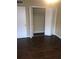 Bedroom with hardwood floors and an open closet with louvered doors at 315 Wymore Rd # 207, Altamonte Springs, FL 32714