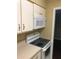 Equipped kitchen featuring white cabinets, microwave, and oven at 315 Wymore Rd # 207, Altamonte Springs, FL 32714