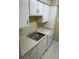 Practical kitchen with white cabinets, a sink, and a dishwasher at 315 Wymore Rd # 207, Altamonte Springs, FL 32714