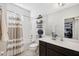 Bathroom featuring a shower-tub combo with a decorative shower curtain and vanity with storage at 3953 Saltmarsh Loop, Sanford, FL 32773