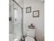 Bathroom with tiled shower, glass door, and motivational decor at 3953 Saltmarsh Loop, Sanford, FL 32773
