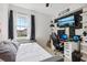 Bedroom with a wall-mounted TV, desk, and window view at 3953 Saltmarsh Loop, Sanford, FL 32773