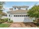 Two-story home with a white exterior, a brick driveway and an attached two-car garage at 3953 Saltmarsh Loop, Sanford, FL 32773