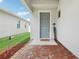 Welcoming front entrance with brick pavers, a blue door, and a 'Welcome Home' sign at 3953 Saltmarsh Loop, Sanford, FL 32773