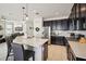 Kitchen featuring modern appliances, an island with barstool seating, and an open layout at 3953 Saltmarsh Loop, Sanford, FL 32773