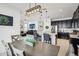 Modern kitchen with dark cabinets, a breakfast bar, and an open view to the living area at 3953 Saltmarsh Loop, Sanford, FL 32773