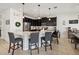 Well-lit kitchen featuring dark cabinetry, stainless appliances, and an island with bar stool seating at 3953 Saltmarsh Loop, Sanford, FL 32773