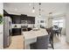 Bright kitchen with stainless steel appliances, a large island, and an adjacent dining area at 3953 Saltmarsh Loop, Sanford, FL 32773