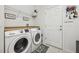 Laundry room includes side-by-side washer and dryer with overhead shelving for added storage at 3953 Saltmarsh Loop, Sanford, FL 32773