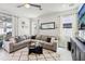 Bright living room with large sectional sofa, decorative rug, and modern entertainment center at 3953 Saltmarsh Loop, Sanford, FL 32773
