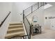 Carpeted staircase with modern railings and a decorative table with stylish accents at 3953 Saltmarsh Loop, Sanford, FL 32773