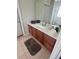 Bathroom vanity with wooden cabinets, white countertop, and large mirror at 4024 Breakview Dr # 10804, Orlando, FL 32819