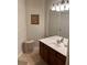Bathroom vanity features a wood cabinet with a white sink and neutral-toned walls at 4024 Breakview Dr # 10804, Orlando, FL 32819