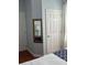 Corner of the bedroom featuring a mirror, two doors, and blue painted walls at 4024 Breakview Dr # 10804, Orlando, FL 32819