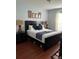 Comfortable bedroom features dark furniture, wood floor, and well-lit window at 4024 Breakview Dr # 10804, Orlando, FL 32819