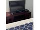 Cozy bedroom features a TV on a dark wood cabinet, and a patterned bedspread at 4024 Breakview Dr # 10804, Orlando, FL 32819