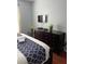 Bedroom with dark wood dresser, tv, light walls, and wood floor at 4024 Breakview Dr # 10804, Orlando, FL 32819