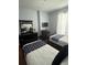 Cozy bedroom featuring two twin beds, dark wood furniture, and plenty of natural light at 4024 Breakview Dr # 10804, Orlando, FL 32819