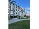 Exterior view of the condo building showcasing well-maintained grounds, sidewalks, and black railed balconies at 4024 Breakview Dr # 10804, Orlando, FL 32819
