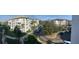 Wide angle view of the condo complex showing ample parking, sidewalks, and lush landscaping under sunny blue skies at 4024 Breakview Dr # 10804, Orlando, FL 32819