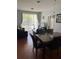 Open concept dining and living area offering modern furniture, wood floors, and plenty of natural light at 4024 Breakview Dr # 10804, Orlando, FL 32819