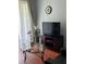 Cozy living room with a glass coffee table, decorative orchids, and a wall-mounted clock at 4024 Breakview Dr # 10804, Orlando, FL 32819