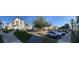 Exterior shot of a parking lot with multiple apartments buildings in the background on a sunny day at 4024 Breakview Dr # 10804, Orlando, FL 32819