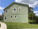 Exterior view of the home's stucco facade and well-maintained lawn at 4324 Paradise Cove Ct, Kissimmee, FL 34746