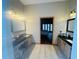 Spacious bathroom with double vanity, natural light, and views into the bedroom at 450 Blue Smoke Ct, Lake Mary, FL 32746