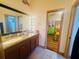 Bathroom with double vanity and views into the bedroom at 450 Blue Smoke Ct, Lake Mary, FL 32746