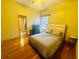 Bright bedroom with hardwood floors, neutral walls, and a large comfortable bed at 450 Blue Smoke Ct, Lake Mary, FL 32746