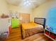 Bedroom with hardwood floors, neutral walls, closet and large window at 450 Blue Smoke Ct, Lake Mary, FL 32746