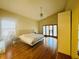 Bright bedroom featuring vaulted ceiling, wood floors, and ensuite bathroom at 450 Blue Smoke Ct, Lake Mary, FL 32746