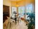 Cozy dining area with a glass table set and a view of the outdoors at 450 Blue Smoke Ct, Lake Mary, FL 32746