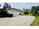 Spacious driveway leading to a two-car garage, with mature trees providing shade at 450 Blue Smoke Ct, Lake Mary, FL 32746