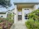 Elegant home entrance with large windows, a decorative door, and vibrant landscaping, creating a welcoming appeal at 450 Blue Smoke Ct, Lake Mary, FL 32746