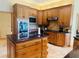 A spacious kitchen featuring custom wood cabinets, an island, and stainless steel appliances at 450 Blue Smoke Ct, Lake Mary, FL 32746