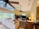 Bright living room features large windows, a fireplace, and vaulted ceilings at 450 Blue Smoke Ct, Lake Mary, FL 32746
