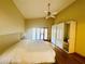Bright main bedroom featuring a vaulted ceiling, ceiling fan, wood floors and private access to lanai at 450 Blue Smoke Ct, Lake Mary, FL 32746