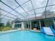 Inviting screened-in pool with an inflatable slide and ample space for outdoor relaxation and recreation at 450 Blue Smoke Ct, Lake Mary, FL 32746