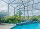 Screened pool area with lush landscaping and a beautiful water feature for relaxation at 450 Blue Smoke Ct, Lake Mary, FL 32746