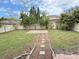 Landscaped backyard with a brick patio and a stone pathway leading through the lawn at 5768 Los Palma Vista Dr, Orlando, FL 32837