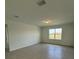 Spacious bedroom with tile flooring, natural light, and neutral walls at 597 Pine Tree Blvd, Lake Alfred, FL 33850
