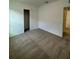 Neutral bedroom features carpet, closet, and interior door at 597 Pine Tree Blvd, Lake Alfred, FL 33850