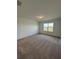 Bright bedroom with carpet, natural light, and ample space at 597 Pine Tree Blvd, Lake Alfred, FL 33850