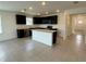 Bright kitchen showcasing an island, tile flooring, and modern appliances at 597 Pine Tree Blvd, Lake Alfred, FL 33850