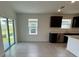 Bright kitchen featuring stainless appliances, tile floors, and access to the patio at 597 Pine Tree Blvd, Lake Alfred, FL 33850